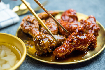 Deep fried chicken wing with garlic sauce and spicy sauce in Korean style served with pickled...