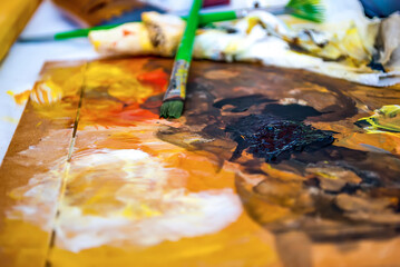 Obraz premium Board with mixed acrylic colors and brush