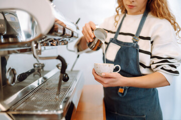 Barista girl preparing deliciouse fresh hot coffee in professional coffee machine. Takeaway food.