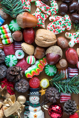 Close up view of assorted nuts, ornaments and festive confections.