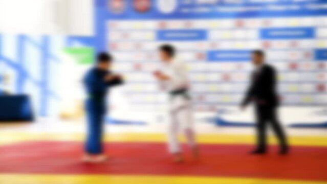 Judo competitions. Young athletes compete on the tatami. Judo. Blurred.