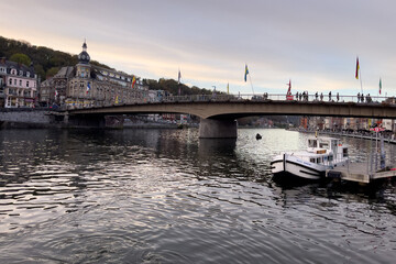 Naklejka premium Tour boat docked on the Meuse river in Dinant, Belgium