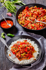 Hoppin John with rice in black bowl, top view