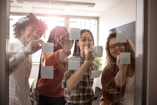 Business people, planning and brainstorming with sticky notes for idea, strategy or collaboration at the office.