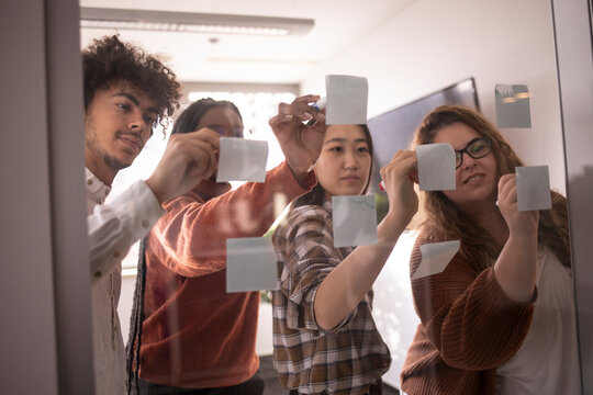 Business people, planning and brainstorming with sticky notes for idea, strategy or collaboration at the office.