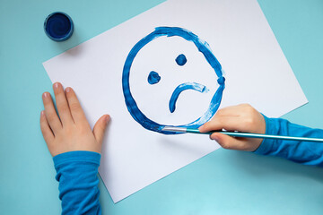 Top view of the drawing sad face.Blue monday and mental health concept.