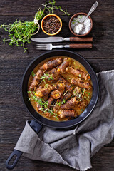 german beef rouladen in thick gravy on pan