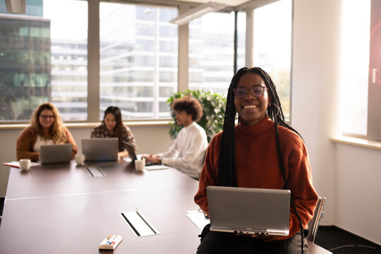 Young woman is the office is using laptop