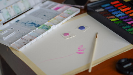 watercolor painting tools on the table.