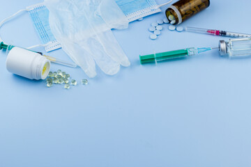 white medical protective glove, medical mask, syringe with needle, vaccination, vial and pills....