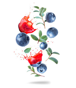 Whole and sliced blueberries with juice splashes in the air isolated on a white background