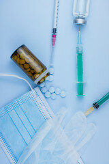 Vertical shot of pharmaceutical syringe with needle in a medicine and pills - illegal doping drugs