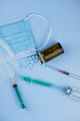 white medical protective glove, medical mask, syringe with needle, vaccination, vial and pills....