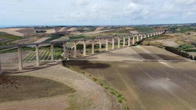 Aerial view of the bridge with fields in the background. Viadotto Carboj, Agrigento, Italy.