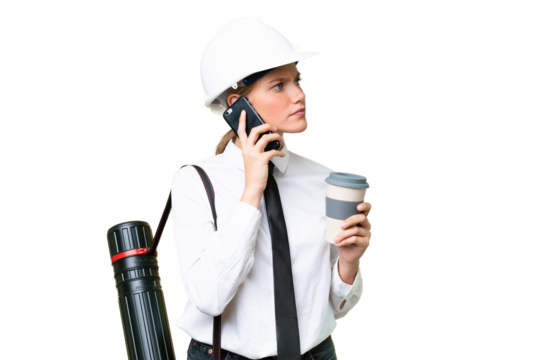 Young architect caucasian woman with helmet and holding blueprints over isolated background holding coffee to take away and a mobile