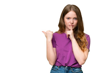 Young pretty woman over isolated background pointing to the side and doing silence gesture