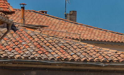 House roofs in a typical provence town, Arles, France. Houses with orange tiled roofs.