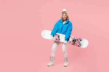 Full body snowboarder smiling fun woman wear blue suit goggles mask hat ski padded jacket hold...