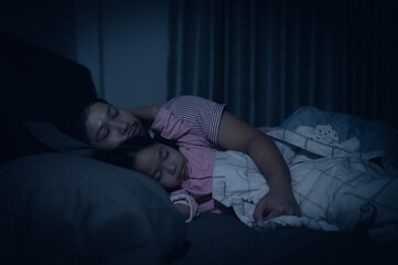 Dad and daughter sleep on the bed in bedroom,Watch cartoon with phone,Father day concept,Single...