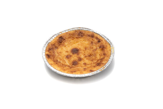 La Quesada Pasiega is a typical dessert from the Valles Pasiegos region, in Cantabria (Spain) made with curdled milk, eggs, flour, lemon peel and butter. Isolated on white background.