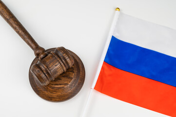 Russian federation flag and judge's gavel on a white table. 