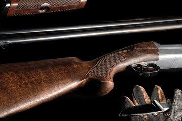 butt of dark walnut and hunting trunks on a black background
