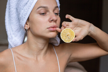 Beauty portrait woman with a towel wrapped around her head with lemon