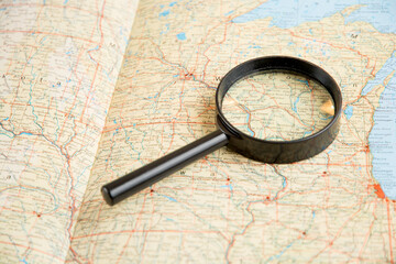 world atlas under magnifying glass