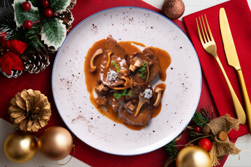 Veal fricandó on table with Christmas decoration. Typical Spanish recipe for Christmas week.