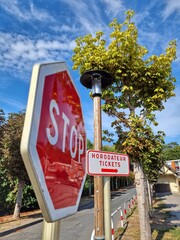 Stop sign and paid parking sign in Etretat, Normandy, France.