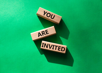 You are invited symbol. Wooden blocks with words You are invited. Beautiful green background. Business and You are invited concept. Copy space.