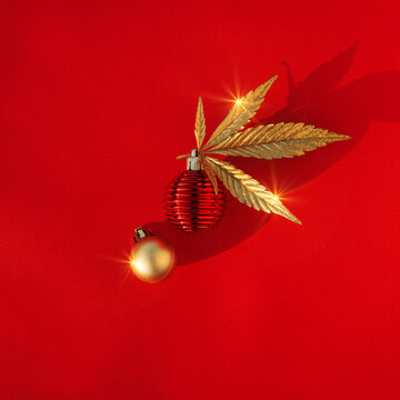Abstract red christmas background with golden cannabis, marijuana leaf and festive decor.