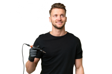 Tattoo artist caucasian man over isolated background thinking an idea while looking up