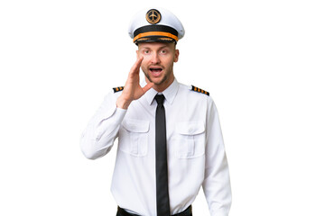Airplane pilot man over isolated background with surprise and shocked facial expression