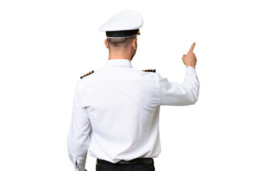 Airplane pilot man over isolated background pointing back with the index finger