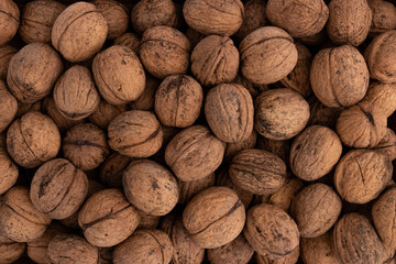 background of unpeeled walnuts close up top view