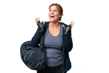 Middle-aged sport woman with sport bag over isolated background with surprise facial expression