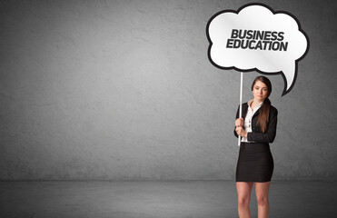 business person in casual holding road sign