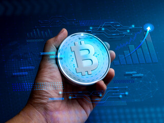 Bitcoin, digital assets in the hand with tech graphics, business growth graph, global icon on blue...