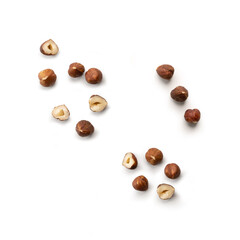 Pieces of tasty hazelnuts on white background
