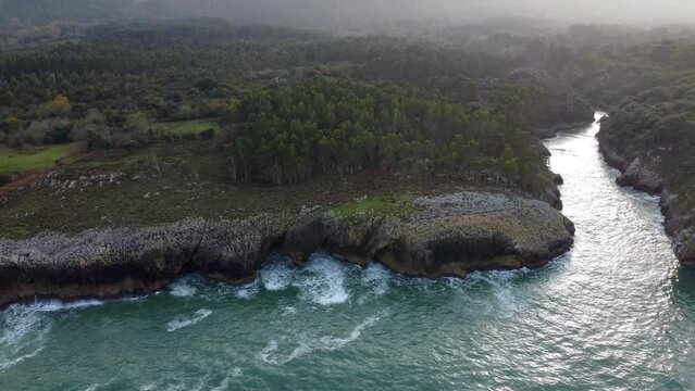 Coast with cliffs in Llanes, Asturias. Mouth of the Puron river.