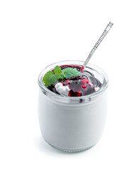 Fresh natural homemade organic yogurt with blueberry jam in a glass jar isolated on white