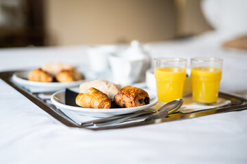 Continental breakfast coffee milk orange juice and croissant