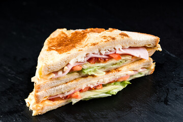 Fresh toasted bread with chicken ham, lettuce, cheese and tomatoes.