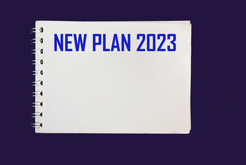 NEW PLAN 2023. text on notepad on blue background