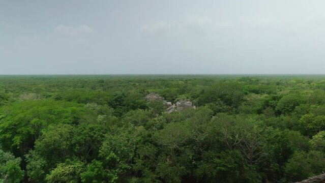 Drone view of the Ek Balam archaeological site surrounded by green trees in  Mexico