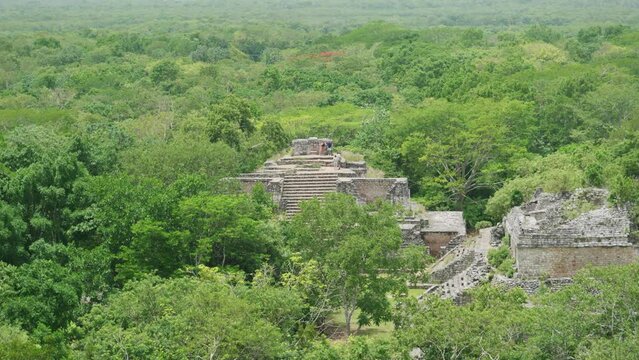 Drone view of the Ek Balam archaeological site surrounded by green trees in  Mexico