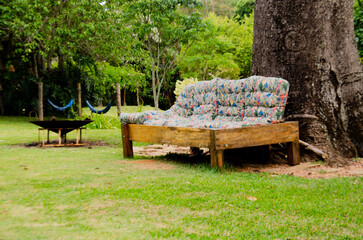 Sofa leaning against a tree in an open area. References for home decor. website house.