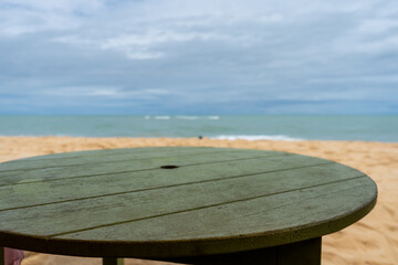 Fototapeta premium Wooden table on the beach