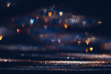 Glowing in the dark colorful heart shaped bokeh lights. Valentine's Day texture background - obrazy, fototapety, plakaty